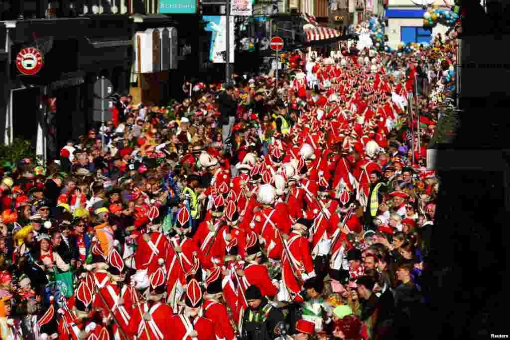 Revelers take part in the traditional "Rosenmontag" Rose Monday carnival parade in Cologne, Germany.