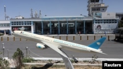 FILE - A model of an airplane is seen in front of the international airport in Kabul, Afghanistan, Sept. 5, 2021. (WANA via Reuters)