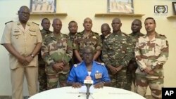 FILE - Colonel Major Amadou Abdramane makes a statement on July 26, 2023, in Niamey, Niger, as a delegation of military officers appeared on Niger state TV to announce their coup. Journalists have found it increasingly risky to report on the junta. (ORTN via AP)