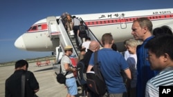 FILE - Passengers board an Air Koryo plane at the Pyongyang International Airport, in Pyongyang, North Korea, June 27, 2015.