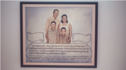 A painting representing Ros Sopheap's family as a gift from her GADC's colleagues is displayed at a wall along the stairway in her home. (Khan Sokummono/VOA Khmer)