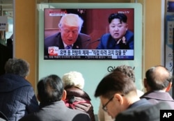 FILE - People watch a TV screen showing images of U.S. President Donald Trump, left, and North Korean leader Kim Jong Un at the Seoul Railway Station in Seoul, South Korea, Nov. 21, 2017.