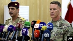 U.S. Army Col. Ryan Dillon, right, spokesman for Operation Inherent Resolve, the U.S.-led coalition against the Islamic State group, and Iraq armed forces spokesman Gen. Yahyah Rasul hold a press conference in Baghdad, Iraq, Sept. 21, 2017.