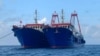 In this photo provided by the National Task Force-West Philippine Sea, Chinese vessels are moored at Whitsun Reef, South China Sea, on March 27, 2021.
