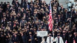 Athletes from the United States of America walk during the opening ceremony in the Olympic Stadium at the 2020 Summer Olympics, July 23, 2021, in Tokyo, Japan.
