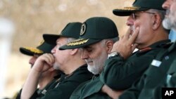 Gen. Qassem Soleimani, center, who heads the elite Quds Force of Iran's Revolutionary Guard attends a graduation ceremony of a group of the guard's officers in Tehran, Iran, June 30, 2018.