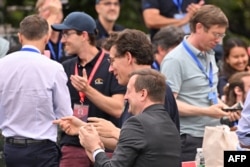 French Ambassador to China Bertrand Lortholary, front center, and National Center for Space Studies President Philippe Baptiste, back center, applaud following the launch of a rocket carrying a satellite jointly developed by China and France on June 22, 2024.
