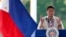 FILE - Philippine President Rodrigo Duterte gestures while speaking following a wreath-laying ceremony in observance of National Heroes Day, Aug. 29, 2016 at the Heroes Cemetery in suburban Taguig city, east of Manila.