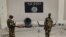FILE - Soldiers stand at a checkpoint in front of a Boko Haram flag the Nigerian city of Damasak, Nigeria, March 18, 2015. In Senegal, 29 suspects are awaiting a ruling on terrorism-related charges. Most of the suspects are believed to have fought for Boko Haram in Nigeria, while others fought for jihadists in Libya and Mali.