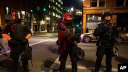 FILE - Portland police stand guard in Portland, Oregon, Aug. 29, 2020.