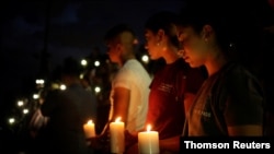 Mourners take part in a vigil at El Paso High School after a mass shooting at a Walmart store in El Paso, Texas, Aug. 3, 2019. 