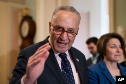 Senate Minority Leader Chuck Schumer, D-N.Y., joined at right by Sen. Amy Klobuchar, D-Minn., speaks to reporters at the Capitol in Washington, April 9, 2019.