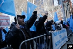 FILE - Uighurs and their supporters protest in front of the Permanent Mission of China to the United Nations in New York, March 15, 2018. Over recent months, monitoring groups and witnesses say Uighurs have been sent into detention and indoctrination centers.