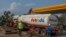 FILE - A tanker offloads fuel at a Petroda filling station in Lilongwe, Malawi, October 1, 2021. A trainload of diesel fuel arrived July 23, 2024, in Malawi for the first time in 21 years, signaling the end of shortages. 