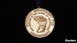 FILE - The National Endowment for Democracy's Democracy Service Medal is displayed at the Library of Congress in Washington. 