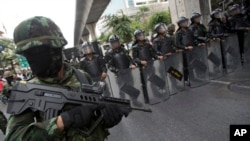 Thai soldiers guard during a protest against the coup in Bangkok, Thailand Saturday, May 24, 2014.