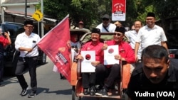 Pasangan bakal calon yang diusung PDIP Solo diarak menggunakan becak saat mendaftar di kantor DPC PDI P Solo, Senin (23/9). (Foto: VOA/ Yudha Satriawan)