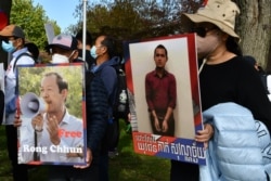 បាតុករ​កាន់​ផ្ទាំង​បដា​ដែល​មាន​រូប​លោក រ៉ុង ឈុន មេដឹកនាំសហជីព​ និង​យុវជន​ដែល​បាន​ជាប់​ពន្ធនាគារ​ដោយ​សារ​ការ​បញ្ចេញ​មតិ​រិះគន់​តាម​បណ្តាញ​សង្គម ក្នុង​អំឡុង​បាតុកម្ម​មួយ​នៅ​រដ្ឋធានី​វ៉ាស៊ីនតោន កាល​ពី​ថ្ងៃ​ទី​២២ ខែ​តុលា ឆ្នាំ​២០២១។ (ម៉ែន គឹមសេង/វីអូអេ)