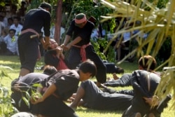 Cambodian students from Royal University of Fine Arts reenact torture and execution by the Khmer Rouge during their reign of terror in the 1970s in an event hosted by the ruling Cambodian People's Party to mark the annual Day of Anger at Choeung Ek, a former Khmer Rouge "killing field," outside Phnom Penh, Cambodia, Monday, May 20, 2019. (AP Photo/Heng Sinith)