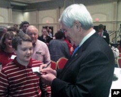 美国共和党总统参选人、国会众议院前议长金里奇给小朋友签名