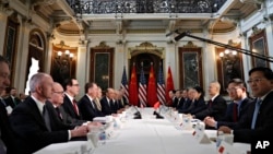 FILE - U.S. and Chinese delegations meet in the Indian Treaty Room in the Eisenhower Executive Office Building on the White House complex, during U.S.-China trade talks, Feb. 21, 2019, in Washington.