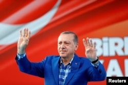 Turkey's President Tayyip Erdogan greets people at the United Solidarity and Brotherhood rally in Gaziantep, Turkey, Aug. 28, 2016.