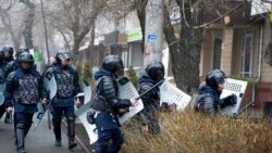 Riot police walk to block demonstrators during a protest in Almaty, Kazakhstan, Jan. 5, 2022.