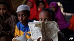 Somali refugee boys recite the Koran at a Madrassa, or Islamic religious school, at Dadaab refugee camp, Dec. 19, 2017.