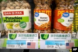 FILE - Imported nuts from the United States are displayed at a supermarket in Beijing, March 23, 2018. China announced a $3 billion list of U.S. goods including pork, apples and steel pipe on Friday that it said may be hit with higher tariffs.