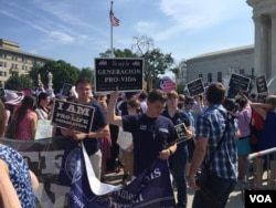 Pro-life demonstrators wave signs and make their voices heard after the Supreme Court upheld abortion rights in a 5-3 decision, in front of the Supreme Court building in Washington, June 27, 2016. (J. Oni / VOA News)