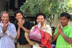 FILE PHOTO - Ouch Leng (third from the left), a Goldman Environmental Prize 2016 winner, and three other environmental activists. (Courtesy photo of CCHR)