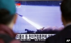 FILE - People watch a TV screen showing a file footage of a missile launch conducted by North Korea, at Seoul Railway Station in Seoul, South Korea, March 18, 2016.
