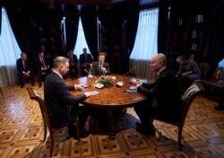 Ukrainian President Volodymyr Zelenskiy, center, Poland's President Andrzej Duda, left, and Lithuania's President Gitanas Nauseda are seen during their meeting at the presidential residence in Ukraine's, Ivano-Frankivsk region, Dec. 20, 2021. (Ukrainian P