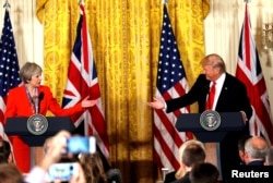 FILE - British Prime Minister Theresa May and U.S. President Donald Trump during their joint news conference at the White House in Washington, Jan. 27, 2017.