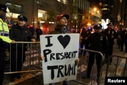 FILE - A supporter of President-elect Donald Trump shouts back at opposing demonstrators during a protest against the President-elect in New York, Nov. 11, 2016.