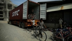 A small team helps to unload, wash, and repair 400 bikes from any damages caused in transit. (Kiana Duncan/VOA Khmer)