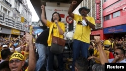 FILE - Pro-democracy group "Bersih" (Clean) chairwoman Maria Chin Abdullah, center, rallies supporters as they prepare to march toward Dataran Merdeka in Malaysia's capital city of Kuala Lumpur, Aug. 29, 2015.