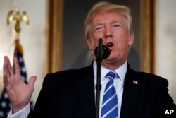 President Donald Trump speaks in the Diplomatic Reception Room of the White House, Nov. 15, 2017, in Washington.