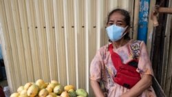 Bo Phally sits near a her self-made stall in Wat Broyuvong pagoda, in Phnom Penh, Cambodia, on Tuesday, March 31, 2020.(Malis Tum/VOA Khmer)