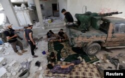 Rebel fighters from Jaysh al-Sunna, operating under a coalition of rebel groups called Jaish al-Fatah, or the army of conquest, rest in Aziziyah village, southern Aleppo countryside, Syria, May 17, 2016.