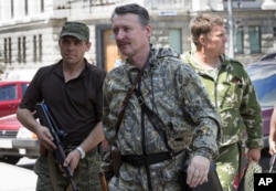 UKRAINE – Igor Girkin also known as Igor Strelkov, a pro-Russian commander, center, arrives for the wedding of platoon commander Arsen Pavlov and Elena Kolenkina in the city of Donetsk, eastern Ukraine. July 11, 2014