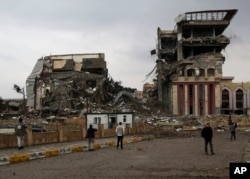 Students inspect their badly damaged university after it was recently liberated from Islamic State militants, Mosul, Iraq, Jan. 22, 2017.