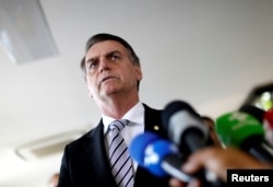 Brazil's President-elect Jair Bolsonaro talks to the media, in Brasilia, Brazil, Nov. 7, 2018.