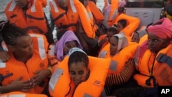 A rescue boat is filled with migrants taken from a vessel in the Mediterranean Sea off the coast of Libya in this Oct. 4, 2016 image taken from video.