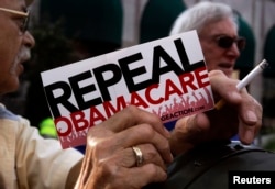 FILE - Demonstrators denouncing Obamacare during a protest in Indianapolis, Indiana, Aug. 26, 2013.