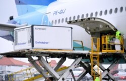 Para petugas sedang menurunkan kargo berisi vaksin Covid-19 yang dikembangkan Sinovac Biotech, perusahaan farmasi asal China, di Bandara Internasional Soekarno-Hatta, Tangerang, Banten, Kamis, 31 Desember 2020. Kargo ini adalah pengiriman kedua vaksin Sin