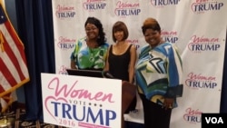 Social media personalities Lynette Hardaway, left, and Rochelle Richardson, right, known collectively as "Diamond and Silk," pose with actress Stacey Dash at the unveiling of the Women Vote Trump Super PAC in Washington, D.C., June 9, 2016. (W. Gallo/VOA)