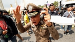 A police officer reacts during clashes between pro-democracy demonstrators and royalists during a Thai anti-government mass protest, on the 47th anniversary of the 1973 student uprising, in Bangkok, Thailand October 14, 2020.