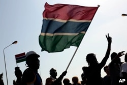 Gambians celebrate the victory of opposition coalition candidate Adama Barrow against longtime President Yahya Jammeh in the streets of Serrekunda, Gambia, Dec. 2, 2016.