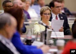 Indiana Secretary of State Connie Lawson reads notes that were handed out on voter registration during the National Association of Secretaries of State conference in Indianapolis, July 8, 2017.